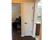 Hallway view to living room and bathroom with black furniture at 15976 Sw 23Rd Court Rd, Ocala, FL 34473