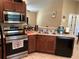Well-equipped kitchen with tile floors, dark wood cabinets, and stainless steel appliances at 15976 Sw 23Rd Court Rd, Ocala, FL 34473