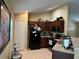 Well-equipped kitchen with tile floors, dark wood cabinets, and modern appliances at 15976 Sw 23Rd Court Rd, Ocala, FL 34473