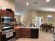 Well-equipped kitchen with tile floors, dark wood cabinets, and modern appliances at 15976 Sw 23Rd Court Rd, Ocala, FL 34473
