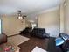 Spacious living room with dark wood floors, ceiling fan, and modern black leather furniture at 15976 Sw 23Rd Court Rd, Ocala, FL 34473