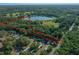 Aerial view showing the property boundary line and the nearby lake at 16571 Se 95Th Street Rd, Ocklawaha, FL 32179