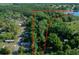 Aerial view showcasing the property boundary with a lake and wooded surroundings at 16571 Se 95Th Street Rd, Ocklawaha, FL 32179