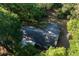 Aerial view of the home's roof, nestled among lush trees, showcasing privacy and expansive grounds at 16571 Se 95Th Street Rd, Ocklawaha, FL 32179