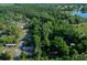 Aerial view showcasing the property within a wooded area, pinpointing its location at 16571 Se 95Th Street Rd, Ocklawaha, FL 32179