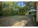 Expansive backyard featuring ample green space and the edge of a screened in porch at 16571 Se 95Th Street Rd, Ocklawaha, FL 32179
