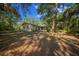 View of the backyard with mature trees and leaves at 16571 Se 95Th Street Rd, Ocklawaha, FL 32179