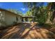 View of the back of the house with mature trees and leaves at 16571 Se 95Th Street Rd, Ocklawaha, FL 32179