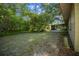 Expansive backyard featuring ample green space and the edge of a screened in porch at 16571 Se 95Th Street Rd, Ocklawaha, FL 32179