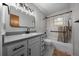 Bathroom featuring a white vanity, shower-tub combo, and modern light fixtures at 16571 Se 95Th Street Rd, Ocklawaha, FL 32179