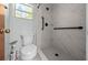 Bathroom featuring updated shower with sleek, white tile and modern fixtures at 16571 Se 95Th Street Rd, Ocklawaha, FL 32179