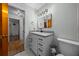 Bathroom featuring a white vanity, modern light fixtures, with adjoined rooms at 16571 Se 95Th Street Rd, Ocklawaha, FL 32179