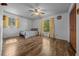 Bedroom with hardwood floors, natural light, ceiling fan, and closet for storage at 16571 Se 95Th Street Rd, Ocklawaha, FL 32179