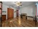 Bedroom featuring hardwood floors, ceiling fan, large closet, and neutral colored walls at 16571 Se 95Th Street Rd, Ocklawaha, FL 32179
