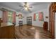Spacious bedroom featuring wood floors, ceiling fan, and built-in shelving and storage at 16571 Se 95Th Street Rd, Ocklawaha, FL 32179