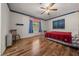 Comfortable bedroom with wood-look flooring, a ceiling fan, and a large window at 16571 Se 95Th Street Rd, Ocklawaha, FL 32179