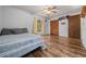 Bedroom featuring hardwood floors, ceiling fan, large closet, and neutral colored walls at 16571 Se 95Th Street Rd, Ocklawaha, FL 32179