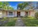 Quaint home featuring a walkway to the front door and colorful shutters, surrounded by greenery at 16571 Se 95Th Street Rd, Ocklawaha, FL 32179