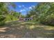 Well maintained front yard leading to a charming single-Gathering home with a red garage door at 16571 Se 95Th Street Rd, Ocklawaha, FL 32179