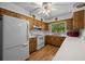 Functional kitchen with wood cabinets and white countertops at 16571 Se 95Th Street Rd, Ocklawaha, FL 32179