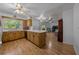 Open concept kitchen with wood cabinets, a central island, and an adjacent living area at 16571 Se 95Th Street Rd, Ocklawaha, FL 32179