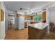 Open kitchen with island, wood cabinetry, and modern appliances at 16571 Se 95Th Street Rd, Ocklawaha, FL 32179