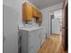 Well-lit laundry room with washer, dryer, and storage cabinets at 16571 Se 95Th Street Rd, Ocklawaha, FL 32179