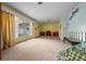 Bright living room with plush carpeting, yellow walls, and large window allowing for ample natural light at 16571 Se 95Th Street Rd, Ocklawaha, FL 32179