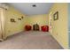 Comfortable living room with plush carpet, ample natural light, and tastefully painted walls in warm yellow tones at 16571 Se 95Th Street Rd, Ocklawaha, FL 32179