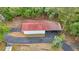 Aerial view of the building with red roof and covered parking among the trees at 16891 Ne 243Rd Place Rd, Fort Mc Coy, FL 32134