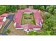 Aerial view showcasing the expansive estate with a red-tiled roof and central courtyard at 16891 Ne 243Rd Place Rd, Fort Mc Coy, FL 32134