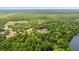 Aerial view of property surrounded by trees and near the lake at 16891 Ne 243Rd Place Rd, Fort Mc Coy, FL 32134