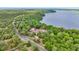 Stunning aerial view of the home and lake, surrounded by lush greenery at 16891 Ne 243Rd Place Rd, Fort Mc Coy, FL 32134