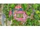 Aerial view showcases the home's red tile roof, courtyard, surrounding trees, and driveway layout at 16891 Ne 243Rd Place Rd, Fort Mc Coy, FL 32134