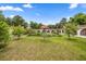 Wide-angle view of the lush backyard, complementing the home's design and ideal for outdoor relaxation and entertainment at 16891 Ne 243Rd Place Rd, Fort Mc Coy, FL 32134