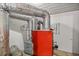 Basement view showing HVAC system components with metal ductwork and a red furnace at 16891 Ne 243Rd Place Rd, Fort Mc Coy, FL 32134