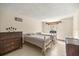 Bright bedroom with two twin beds, tiled floor, and a dark wood dresser at 16891 Ne 243Rd Place Rd, Fort Mc Coy, FL 32134