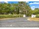 View of the driveway leading to this inviting property, showcasing mature landscaping at 16891 Ne 243Rd Place Rd, Fort Mc Coy, FL 32134