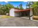 Exterior side of the building shows a concrete pad with covered storage space at 16891 Ne 243Rd Place Rd, Fort Mc Coy, FL 32134
