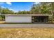 Side of the building shows a concrete pad with covered parking and storage at 16891 Ne 243Rd Place Rd, Fort Mc Coy, FL 32134