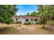 Home's facade features arched windows and a covered entry way at 16891 Ne 243Rd Place Rd, Fort Mc Coy, FL 32134