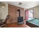 A cozy game room with a vintage fireplace and a pool table for entertaining guests at 16891 Ne 243Rd Place Rd, Fort Mc Coy, FL 32134