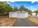Exterior of the garage with a metal door and a decorative star on the front at 16891 Ne 243Rd Place Rd, Fort Mc Coy, FL 32134