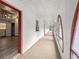 Bright hallway features unique, red-trimmed windows and a glimpse into an adjacent living space at 16891 Ne 243Rd Place Rd, Fort Mc Coy, FL 32134