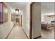 Long hallway leading to bedrooms, featuring neutral walls and tiled flooring throughout at 16891 Ne 243Rd Place Rd, Fort Mc Coy, FL 32134