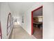 Hallway with arched windows and a red-trimmed doorway leading to a carpeted room at 16891 Ne 243Rd Place Rd, Fort Mc Coy, FL 32134