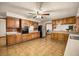 Well-lit kitchen featuring tile floors, wooden cabinets, and modern appliances at 16891 Ne 243Rd Place Rd, Fort Mc Coy, FL 32134