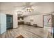 Open living room featuring wood-look floors, access to storage, kitchenette, and comfortable seating at 16891 Ne 243Rd Place Rd, Fort Mc Coy, FL 32134