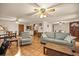 Spacious living room featuring tile floors, ceiling fans, and comfortable seating at 16891 Ne 243Rd Place Rd, Fort Mc Coy, FL 32134