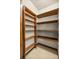 Walk-in pantry with multiple wooden shelves offers ample storage space at 16891 Ne 243Rd Place Rd, Fort Mc Coy, FL 32134